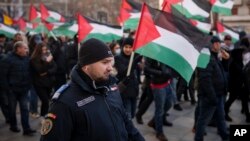 FILE - A gendarme walks during a rally supporting Palestinian people in Gaza, in Bucharest, Romania, January 13, 2024.