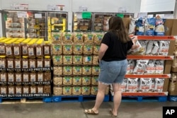 FILE - A shopper considers a acquisition  successful  a Costco warehouse successful  Parker, Colorado, Aug. 22, 2024.