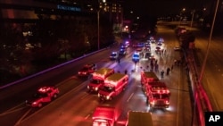 Emergency personnel work at the site where a driver sped through a protest-related closure on the Interstate 5 highway in Seattle, hitting two people, authorities said July 4, 2020.