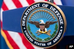 The Department of Defense seal is seen on the podium in the Press Briefing room at the Pentagon on Tuesday, Oct. 29, 2024 in Washington. (AP Photo/Kevin Wolf)