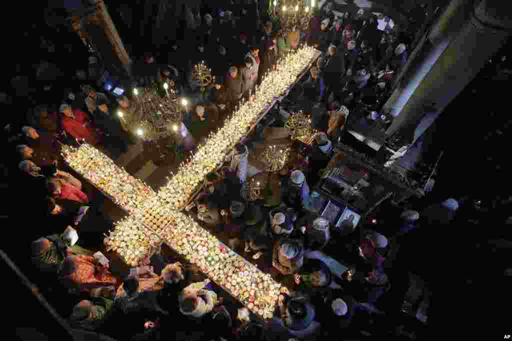 Worshipers gather around candles during Mass for the &#39;sanctification of honey&#39; at the Presentation of the Blessed Virgin church in the town of Blagoevgrad, some 100 km (62 miles) south of the Bulgarian capital.