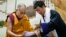 Lobsang Sangay, prime minister of the Tibetan government-in-exile, right, presents a document to spiritual leader the Dalai Lama at the Tibetan Children’s Village School in Dharmsala, India, June 5, 2014.