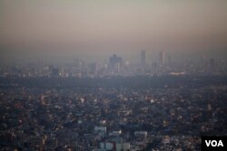 FILE - Mexico's new climate law promises to reduce greenhouse gas emissions by 30% by 2020, which should make a difference in Mexico City, among the most polluted cities in the world.