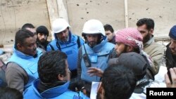 Miembros de Naciones Unidas negocian con civiles dentro de la sitiada ciudad de Homs.