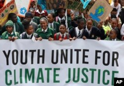 FILE - Young people take part in a protest calling for the government to take immediate action against climate change in Cape Town, South Africa, Sept. 24, 2022.