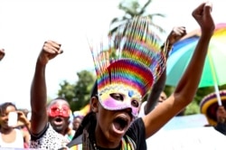 FILE - People parade in celebration of the annulment of an anti-homosexuality law by Uganda's constitutional court in Entebbe, Uganda, Aug. 9, 2014. LGBTQ people continued, however, to face major discrimination in the country.