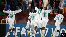 Nigeria players celebrate their teammate Musa Muhammed's goal against Mexico during the World Cup U-17 final soccer match between Nigeria and Mexico at Mohammad Bin Zayed stadium in Abu Dhabi, United Arab Emirates, Friday, Nov. 8, 2013. (AP Photo/Hassan A