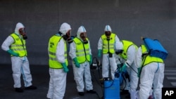 Spanish Royal guard soldiers disinfect a hospital to prevent the spread of the new coronavirus in Madrid, Spain, March 29, 2020.