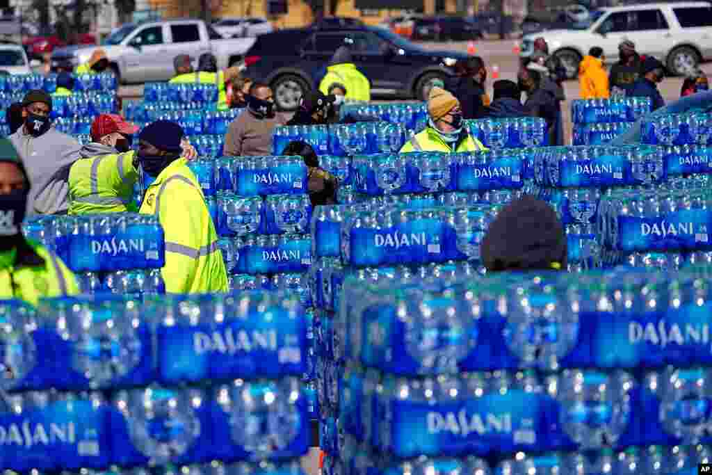 Water to be loaded into vehicles is stacked at a City of Houston water distribution site. The location was set up to provide bottled water to individuals while the city remains on a boil water notice or because of frozen pipes at home.