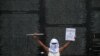 Un activista actúa frente al Monumento a la Memoria y la Verdad durante una protesta para conmemorar el 29 aniversario de la firma de los acuerdos de paz que pusieron fin a la Guerra Civil de El Salvador en el Parque Cuscatlán en San Salvador, el 16 de enero de 2021.