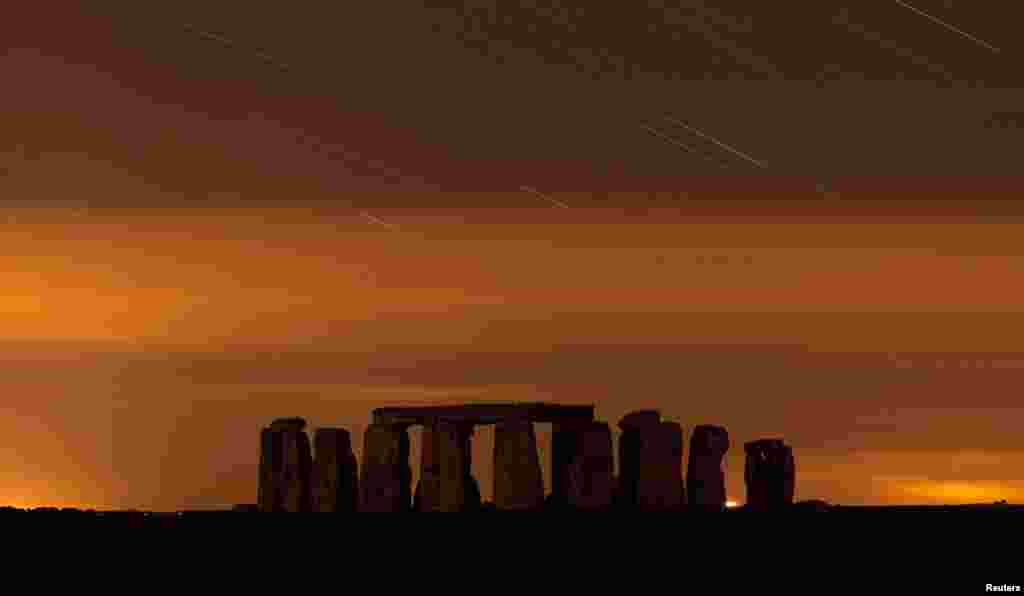 A general view of Stonehenge during the annual Perseid meteor shower in the night sky in Salisbury Plain, southern England. The Perseid meteor shower is sparked every August when the Earth passes through a stream of space debris left by comet Swift-Tuttle.