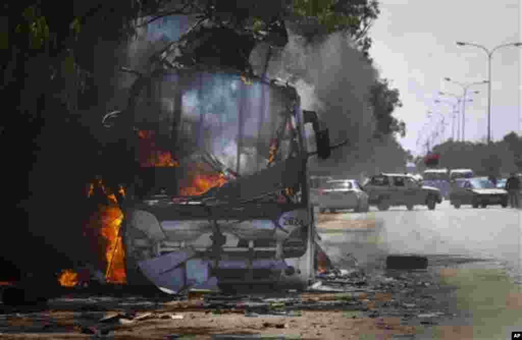 ** CAPTION CORRECTION OMITS THE SECOND SENTENCE AS IT IS UNCLEAR HOW THE BUS WAS DESTROYED AND BY WHOM ** A bus burns on a road leading to the outskirts of Benghazi, eastern Libya, Sunday, March 20, 2011. (AP Photo/Anja Niedringhaus)