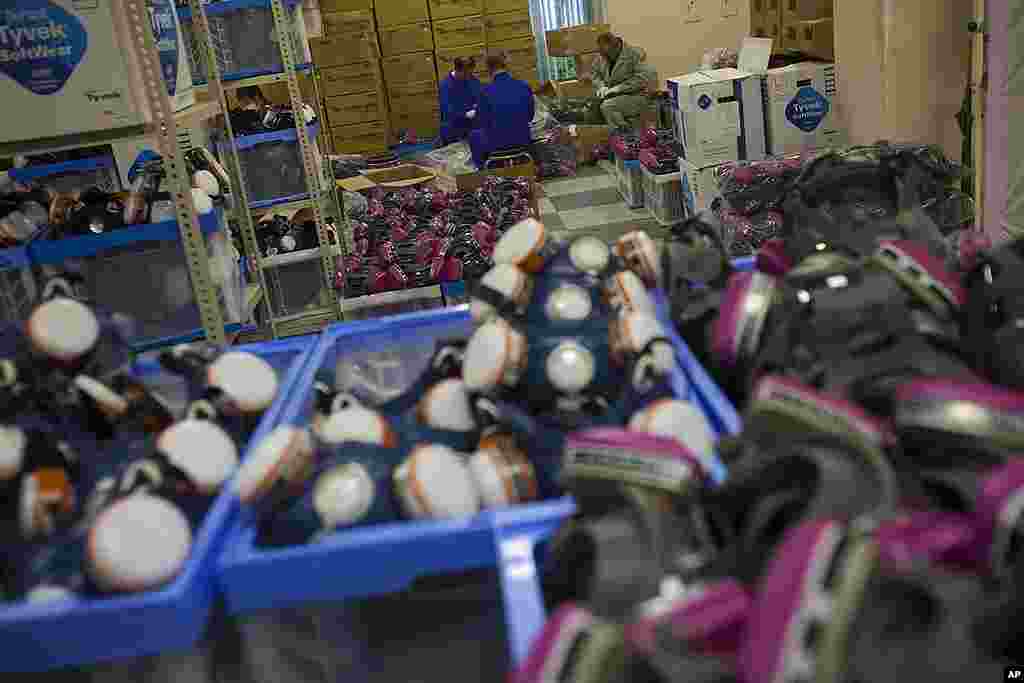 Men sort and clean protective masks at J-Village, a soccer training complex serving as an operation base for those battling Japan&#39;s nuclear disaster, Nov. 11, 2011. 