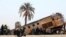 FILE - People gather at the site of a train derailment near Beni Suef, Egypt, Thursday, Feb. 11, 2016 that injured dozens of people were injured as it was traveling north toward Cairo. Railroad accidents due to negligence are common in Egypt.