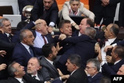 Turkish ruling and opposition lawmakers fight each other in Grand National Assembly of Turkey in Ankara on Aug. 16, 2024.