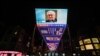 An outdoor screen in Beijing shows a news programme following the death of former US secretary of state Henry Kissinger on November 30, 2023.