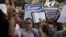 People shout and hold slogans in front of the U.S. embassy during a protest in Cairo, Egypt, September 11, 2012. 