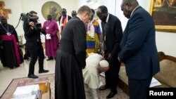 Pope Francis kneels to kiss feet of the President of South Sudan Salva Kiir at the end of a two day spiritual retreat with South Sudan leaders at the Vatican, April 11, 2019. 