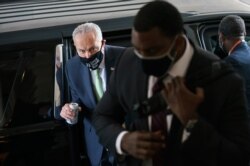 Senate Democratic Majority Leader Chuck Schumer arrives with his security detail as senators convene for a rare weekend session to continue work on the $1 trillion bipartisan infrastructure bill, at the Capitol in Washington, Aug. 8, 2021.