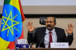 Ethiopian Prime Minister Abiy Ahmed gestures while addressing the House of Peoples Representatives in Addis Ababa, Ethiopia, on Nov. 30, 2020.