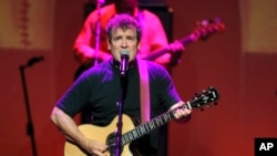 FILE - South African singer Johnny Clegg performs during the "South Africa Night Gala" at the Monte Carlo opera in Monaco, Sept. 29, 2012.