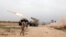 FILE - Iraqi soldiers fire a rocket toward Islamic State militants on the outskirts of the Makhmour south of Mosul, Iraq, March 25, 2016. 