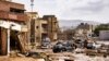 CORRECTION / This handout picture provided by the office of Libya's Benghazi-based interim prime minister on September 11, 2023 shows a view of destroyed vehicles and damaged buildings in the eastern city of Derna, about 290 kilometres east of Benghazi, i