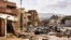 CORRECTION / This handout picture provided by the office of Libya's Benghazi-based interim prime minister on September 11, 2023 shows a view of destroyed vehicles and damaged buildings in the eastern city of Derna, about 290 kilometres east of Benghazi, i