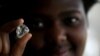 FILE- A visitor holds a diamond during a visit to the De Beers Global Sightholder Sales (GSS) in the capital Gaborone in Botswana, November 24, 2015. 