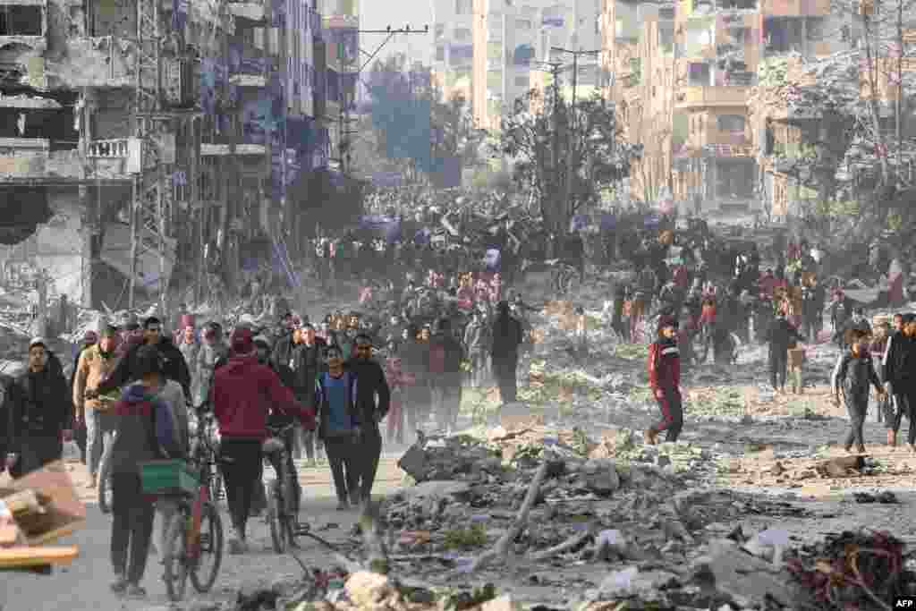 Scores of displaced Palestinians walk along a road in the Saftawi area of Jabalia, as they leave areas near Gaza City where they had taken refuge, toward the further northern part of the Gaza Strip, Jan. 19, 2025.