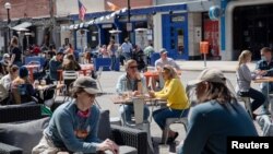 People dine at a restaurant as COVID-19 restrictions are eased in Ann Arbor, Michigan, April 4, 2021.