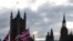 FILE - The sun sets behind the Houses of Parliament in London, Nov. 5, 2019.