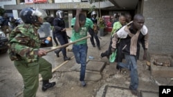 Opposition supporters are beaten with wooden clubs by riot police as they try to flee, during a protest in downtown Nairobi, Kenya, May 16, 2016.