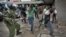 Opposition supporters are beaten with wooden clubs by riot police as they try to flee, during a protest in downtown Nairobi, Kenya, May 16, 2016.
