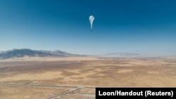 A Loon internet balloon, carrying solar-powered mobile networking equipment flies over the launch site in Winnemucca, Nevada, U.S., in June 27, 2019. 