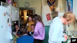 Dutch students chat in the kitchen of their shared house in Leiden, Netherlands Sept. 25, 2020. The coronavirus pandemic is hitting students hard in Leiden, the Netherlands' oldest university city. 