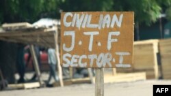 FILE - A sign near a checkpoint of a vigilante group reads Civilian J.T.F or Civilian Joint Task Force in Maiduguri, July 19, 2013. The group released 894 children Friday, according to the United Nations Children Fund.