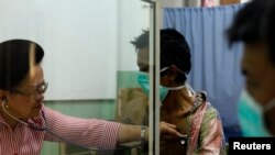 FILE - A doctor checks the lungs of a newly diagnosed tuberculosis patient at the Indonesian Union Against Tuberculosis clinic in Jakarta, April 4, 2011. 