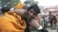 An Indian man whose two relatives died in a stampede at a railway station cries and comforts other relative as they arrive to take the bodies from a morgue, in Allahabad, India, February 11, 2013.