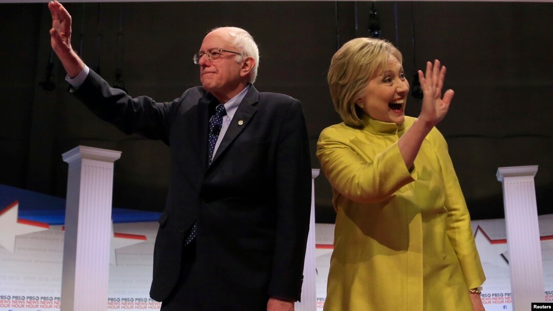 Democratic U.S. presidential candidates Senator Bernie Sanders and former Secretary of State Hillary Clinton arrive on stage ahead of the start of the PBS NewsHour Democratic presidential candidates debate in Milwaukee, Wisconsin, Feb. 11, 2016. 