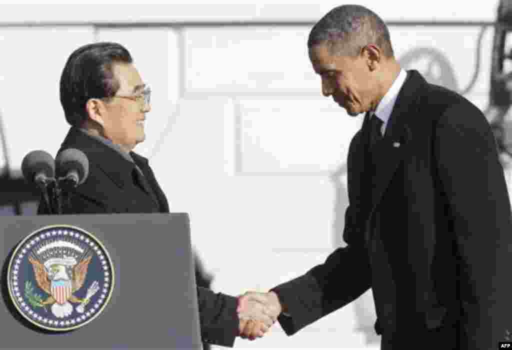 President Barack Obama welcomes China's President Hu Jintao during a state arrival on the South Lawn of the White House in Washington, Wednesday, Jan. 19, 2011. (AP Photo/Charles Dharapak)