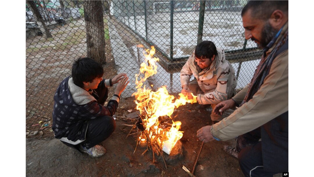 Afghan men warm themselves near a fire in Kabul, Afghanistan, Nov. 10, 2015. Extreme poverty makes difficulties for Afghans to cope with the cold winter.