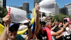 Members of the Venezuelan community protest outside of the Nusr-Et Steakhouse, owned by the celebrity chef Nusret Gokce, Sept. 19, 2018, in Miami, Florida. Venezuelan president Nicolas Maduro was shown in a video feasting on steak in one of the chef's restaurants in Istanbul, Turkey, at a time when many in his troubled nation are going hungry.