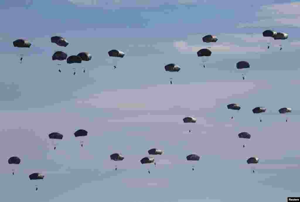 U.S. paratroopers from the 82nd Airborne Division based in Fort Brag, North Carolina, participate in a massive airdrop from C-17 Globemaster aircraft as part of the NATO Exercise Trident Juncture 2015 military exercise at the San Gregorio training grounds outside Zaragoza, Spain.