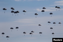 FILE - U.S. paratroopers from the 82nd Airborne Division based in Fort Bragg, N.C., participate in a massive airdrop as part of the NATO Exercise Trident Juncture 2015 at the San Gregorio training grounds outside Zaragoza, Spain, Nov. 4, 2015.