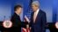 U.S. Secretary of State John Kerry (R) and Colombia's President Juan Manuel Santos shake hands as they address a joint news conference after their meeting at the presidential palace in Bogota, Dec. 12, 2014.