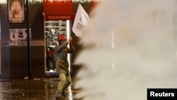 Turkish riot police use water cannons to disperse demonstrators during an anti-government protest in central Istanbul, Dec.27, 2013.