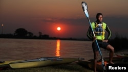 Twenty-year-old Benjamin Mntonintshi, a member of the Soweto Canoe and Recreation Club, poses for a photograph at the Orlando Dam in Soweto, South Africa, August 17, 2021. (REUTERS/Siphiwe Sibeko)