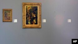 FILE - The empty space where Henri Matisse' painting "La Liseuse en Blanc et Jaune" was hanging, right, is seen next to a painting by Maurice Denis, center, and Pierre Bonnard, left, at Kunsthal museum in Rotterdam, Netherlands, Oct. 16, 2012.