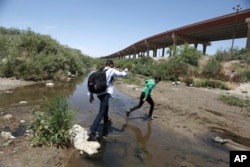 Migrants cross the Rio Grande into the United States, to turn themselves over to authorities and ask for asylum, as seen from Ciudad, Juarez, June 7, 2019. The U.S. Border Patrol’s apprehensions of migrants at the border with Mexico hit their highest level in more than a decade in May.